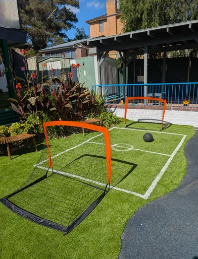 Soccer pitch with two small goals on artificial grass in the Eastwood Blessings outdoor area